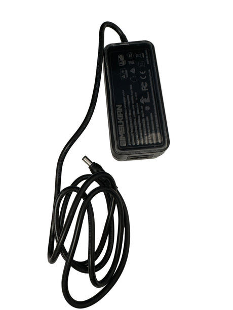 Black power adapter with a coiled cable on a white background