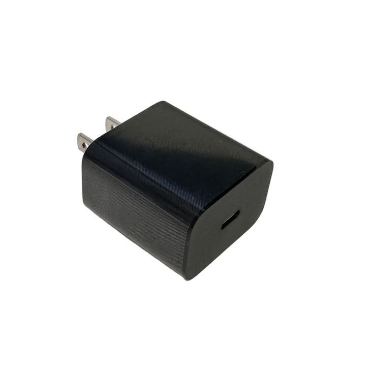 Black power adapter on a white surface