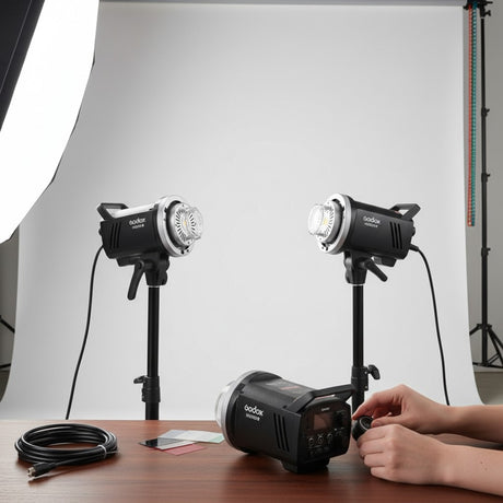 Hypop Godox MS300-V 300W studio flash monolights with LED modelling lamps, black metal body, Bowens mount, three units shown.